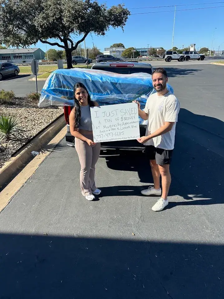 Austin couple smiling with new mattress from Lux Value Mattress